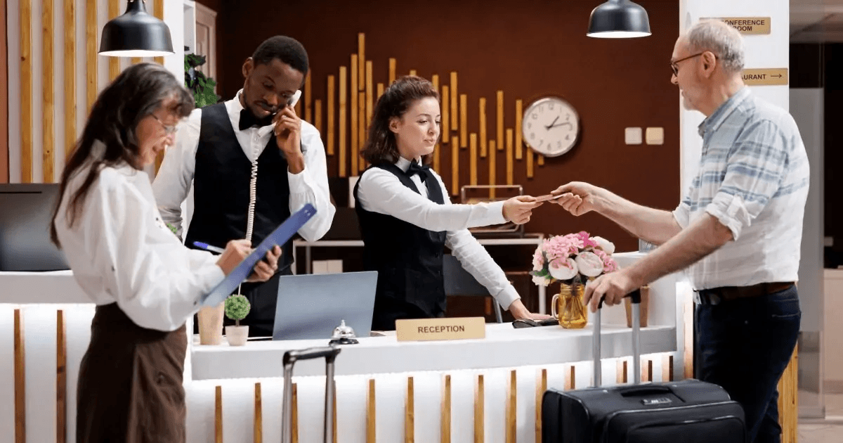 Hotel reception staff welcoming a guest